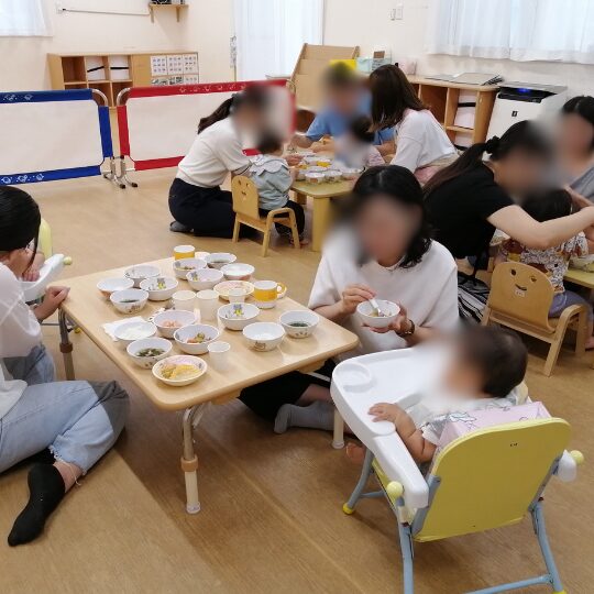 給食を試食する新入園児の保護者と園児